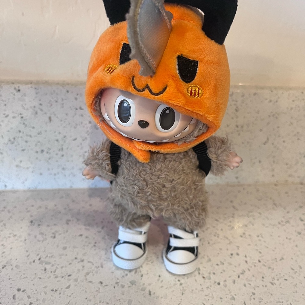 Labubu Sawman Hat with Orange Backpack.